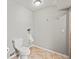 Bathroom featuring a toilet, urinal and tan tiled flooring at 5497 W Prentice Ct, Littleton, CO 80123