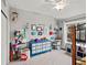 Bright bedroom with a ceiling fan, playful decor, and lots of natural light from the window at 5497 W Prentice Ct, Littleton, CO 80123