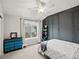 Bedroom with a queen-sized bed, blue dresser and decorative wall accents at 5497 W Prentice Ct, Littleton, CO 80123