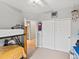 Bedroom with bunk beds and an en suite bathroom, showcasing functional design and natural light at 5497 W Prentice Ct, Littleton, CO 80123