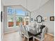 Dining room with large windows, hardwood floors, and a vaulted ceiling at 5497 W Prentice Ct, Littleton, CO 80123