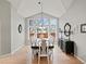 Spacious dining room filled with natural light from large windows, complemented by modern decor and wood floors at 5497 W Prentice Ct, Littleton, CO 80123