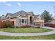 Attractive single-Gathering home featuring a three-car garage, stone accents, and manicured front yard at 5497 W Prentice Ct, Littleton, CO 80123