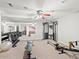 Basement home gym featuring mirrored walls, weights, and modern exercise equipment at 5497 W Prentice Ct, Littleton, CO 80123
