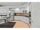 Well-equipped kitchen with stainless steel appliances, granite countertops, and white cabinets; ample storage space at 5497 W Prentice Ct, Littleton, CO 80123