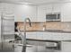 Close up of the kitchen's stainless steel sink and black countertops at 5497 W Prentice Ct, Littleton, CO 80123