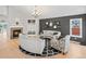 Inviting living room features a fireplace, hardwood floors, neutral decor, and ample natural light at 5497 W Prentice Ct, Littleton, CO 80123