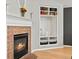 Living Room with white fireplace, mantel and built in shelving at 5497 W Prentice Ct, Littleton, CO 80123
