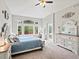 Main bedroom with a large window, vaulted ceiling, and a full en suite bathroom at 5497 W Prentice Ct, Littleton, CO 80123