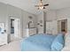 Spacious main bedroom with large window and connecting en suite bathroom at 5497 W Prentice Ct, Littleton, CO 80123