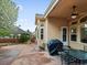 Outdoor patio with stamped concrete, covered seating, and a grill for entertaining at 5497 W Prentice Ct, Littleton, CO 80123