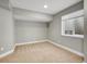 Finished basement space with carpeting and a window for natural light at 6525 S Abilene St, Englewood, CO 80111