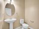 Cozy powder room features pedestal sink and white toilet at 6525 S Abilene St, Englewood, CO 80111