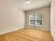 Bright bedroom with two windows offering plenty of natural light and hardwood floors at 6525 S Abilene St, Englewood, CO 80111