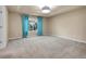 Carpeted bedroom with bright natural light and blue curtains accenting the window at 6525 S Abilene St, Englewood, CO 80111