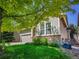 Well-maintained home with lush green lawn, garden and mature trees, offering curb appeal at 6525 S Abilene St, Englewood, CO 80111