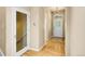 Inviting foyer with hardwood floors, a glass-paneled door and an elegant light fixture at 6525 S Abilene St, Englewood, CO 80111
