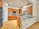 Spacious kitchen with wood cabinets, stainless steel appliances, and a granite-topped island at 6525 S Abilene St, Englewood, CO 80111