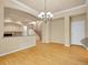Open-concept living space featuring hardwood floors, elegant lighting, and staircase access at 6525 S Abilene St, Englewood, CO 80111