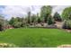 Spacious backyard features mature trees and landscaping for privacy and a natural setting at 2840 Canyon Crest Ln, Highlands Ranch, CO 80126