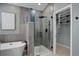 Modern bathroom with sleek glass shower enclosure, soaking tub, and view into a walk-in closet at 2840 Canyon Crest Ln, Highlands Ranch, CO 80126