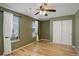 Bedroom featuring hardwood floors, ceiling fan, and natural light from two windows at 2840 Canyon Crest Ln, Highlands Ranch, CO 80126