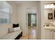 Light-filled hallway with bench seating leading to a bedroom, showcasing the home's layout at 2840 Canyon Crest Ln, Highlands Ranch, CO 80126