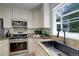 Stylish kitchen boasts granite countertops, stainless steel appliances, and a modern design at 2840 Canyon Crest Ln, Highlands Ranch, CO 80126
