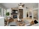 Cozy living room with stone fireplace, ceiling fan and hardwood floors at 2840 Canyon Crest Ln, Highlands Ranch, CO 80126
