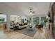 Bright living room with fireplace, large windows, and neutral decor at 2840 Canyon Crest Ln, Highlands Ranch, CO 80126