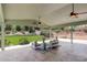 Covered patio with outdoor seating and a view of the landscaped backyard at 2840 Canyon Crest Ln, Highlands Ranch, CO 80126