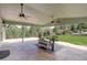Covered outdoor patio featuring seating and a view of the green, landscaped backyard at 2840 Canyon Crest Ln, Highlands Ranch, CO 80126