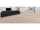 Finished basement featuring a large sofa, bar seating, and neutral carpet at 11412 Autumn Moon St, Littleton, CO 80125