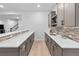 Basement bar area with modern gray cabinetry, quartz countertops, tiled backsplash and wood floors at 11412 Autumn Moon St, Littleton, CO 80125