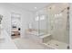 Bathroom showcasing glass enclosed shower and tub with tile surround at 11412 Autumn Moon St, Littleton, CO 80125