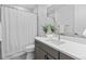 Bathroom with gray vanity, white quartz countertop, and white shower curtain at 11412 Autumn Moon St, Littleton, CO 80125