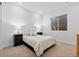 Well-lit bedroom with a comfortable bed, neutral-toned linens, and bedside lamps at 11412 Autumn Moon St, Littleton, CO 80125