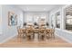 Bright dining area with wood table situated beneath three windows with modern shutters at 11412 Autumn Moon St, Littleton, CO 80125