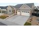 Charming two-story home with a gray exterior, two-car garage, and well-manicured landscaping at 11412 Autumn Moon St, Littleton, CO 80125
