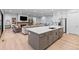 Kitchen with island that flows into the living room, stainless steel appliances and modern cabinetry at 11412 Autumn Moon St, Littleton, CO 80125