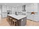 Modern kitchen featuring a large island, stainless steel appliances, and white cabinetry at 11412 Autumn Moon St, Littleton, CO 80125