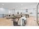 Open-concept living room and kitchen area featuring hardwood floors, neutral colors, and recessed lighting at 11412 Autumn Moon St, Littleton, CO 80125