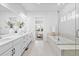 Luxurious main bathroom showcasing a soaking tub, double vanity, and modern finishes at 11412 Autumn Moon St, Littleton, CO 80125