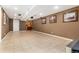 Spacious basement with tile flooring, recessed lighting and a brown accent wall at 23136 Kiowa Rd, Indian Hills, CO 80454