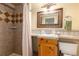 Bathroom featuring tiled shower, decorative mirror, and vanity with sink at 23136 Kiowa Rd, Indian Hills, CO 80454