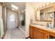 Bright bathroom with walk in shower and wooden cabinets, complemented by tiled flooring at 23136 Kiowa Rd, Indian Hills, CO 80454