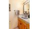 Unique bathroom sink with decorative tiles, complemented by a wrought iron mirror and warm-toned walls at 23136 Kiowa Rd, Indian Hills, CO 80454