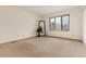 Bright, carpeted bedroom with a view of trees from the window at 23136 Kiowa Rd, Indian Hills, CO 80454