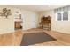 Cozy bedroom with hardwood floors and view into bathroom at 23136 Kiowa Rd, Indian Hills, CO 80454