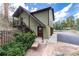 View of the exterior featuring multi-level entrance with a charming walkway and a detached garage at 23136 Kiowa Rd, Indian Hills, CO 80454